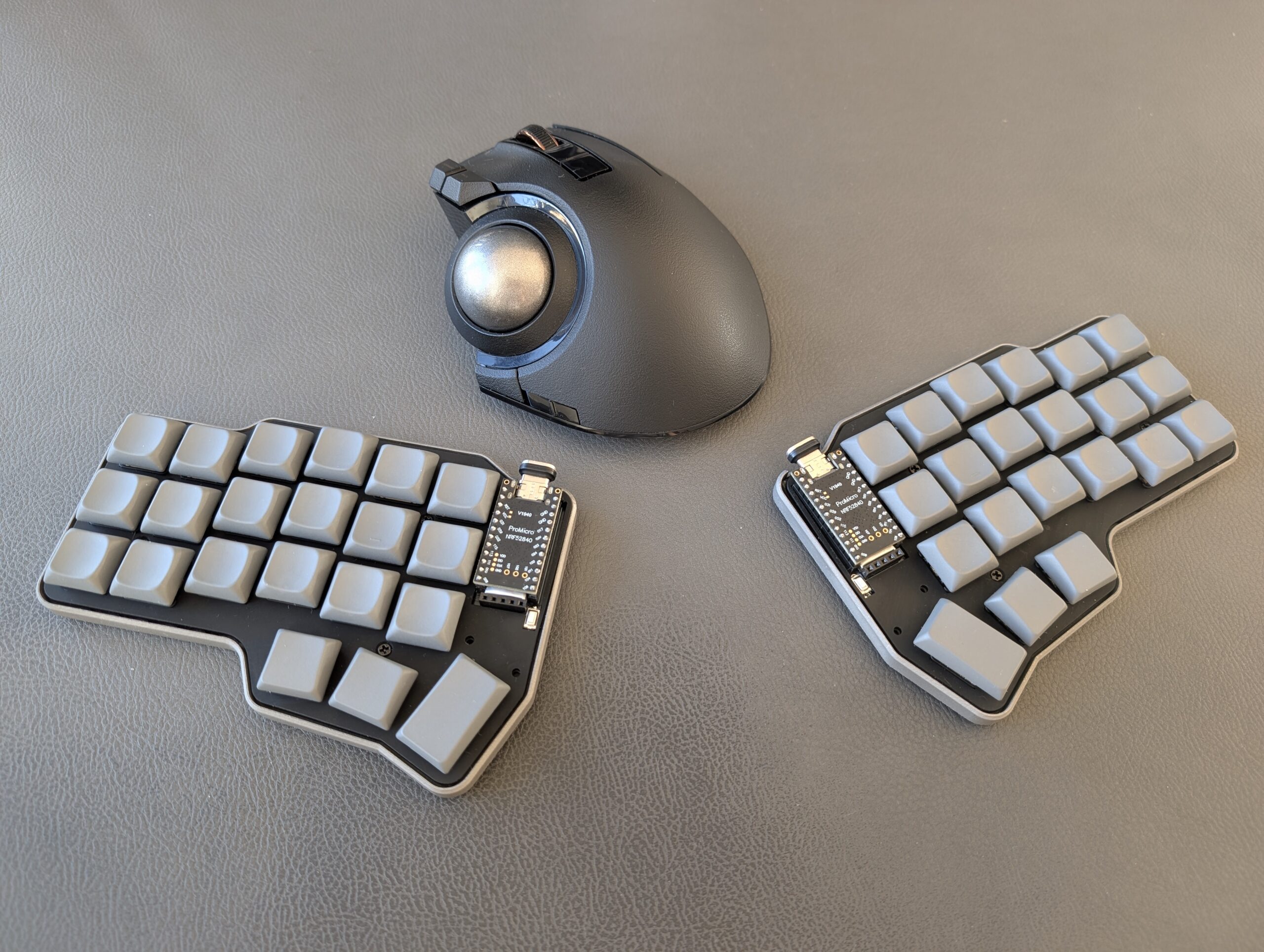 Corne with LDSA keycaps next to ELECOM EX-G Pro trackball